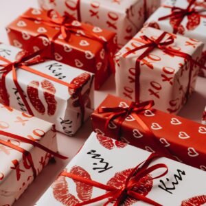 Valentine's Day gifts beautifully wrapped in themed paper with red ribbons, perfect for a romantic celebration.