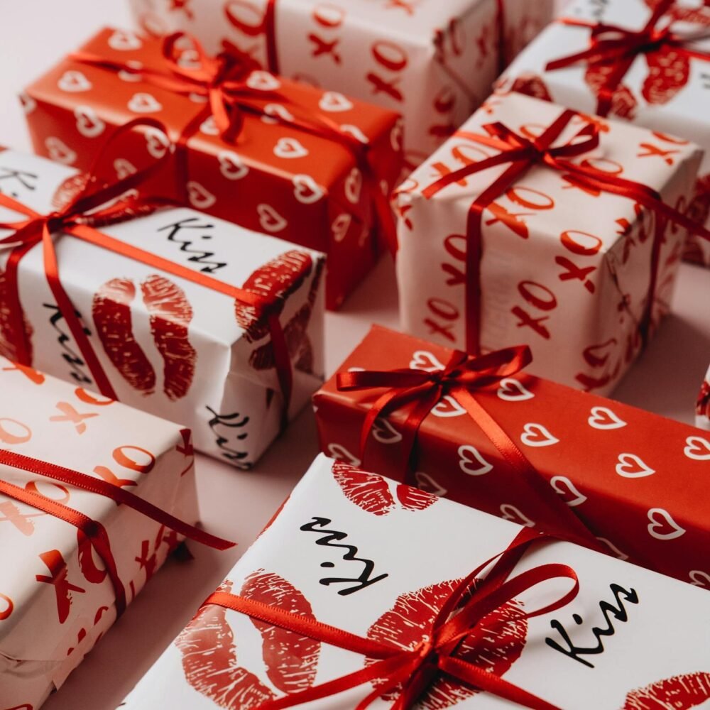 Valentine's Day gifts beautifully wrapped in themed paper with red ribbons, perfect for a romantic celebration.